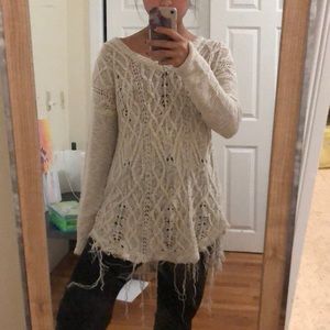 Oversized white knit sweater with distressing